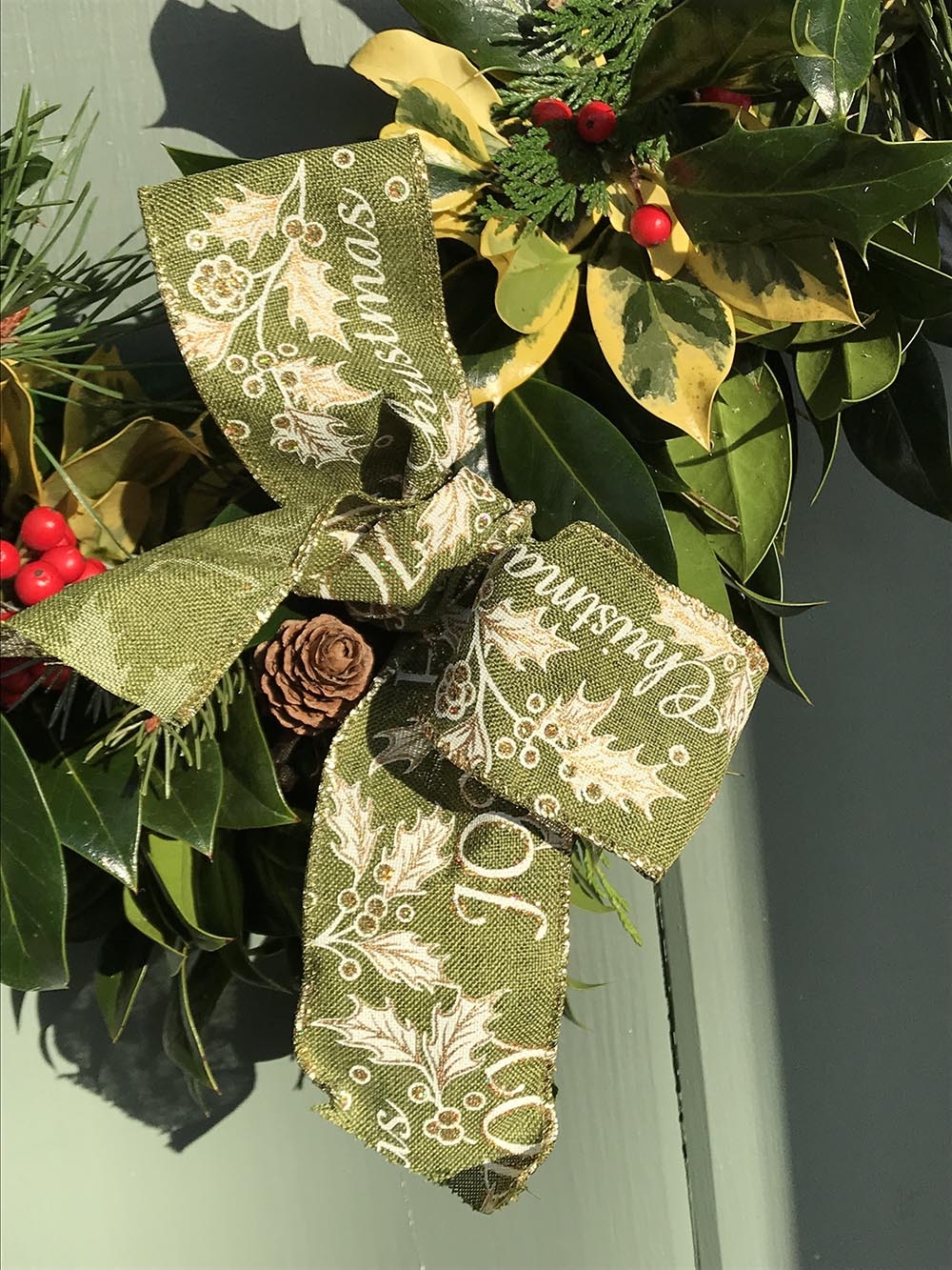 holly wreath with ribbon bow
